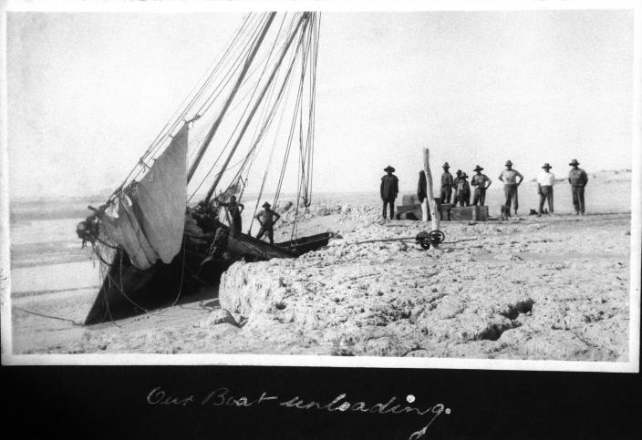 People loading provisions onto a boat. 
